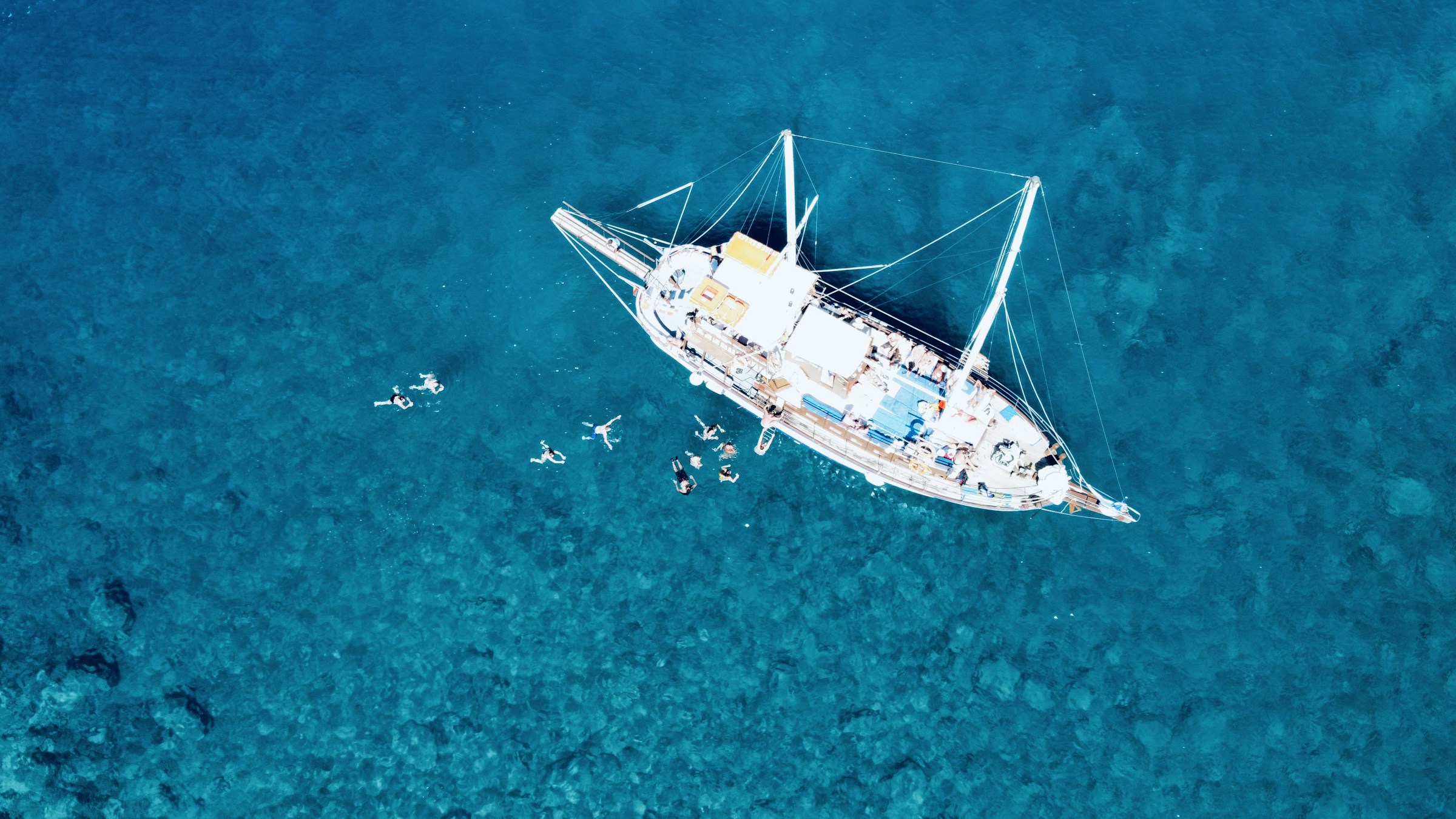 Sailing yacht anchored in clear blue sea